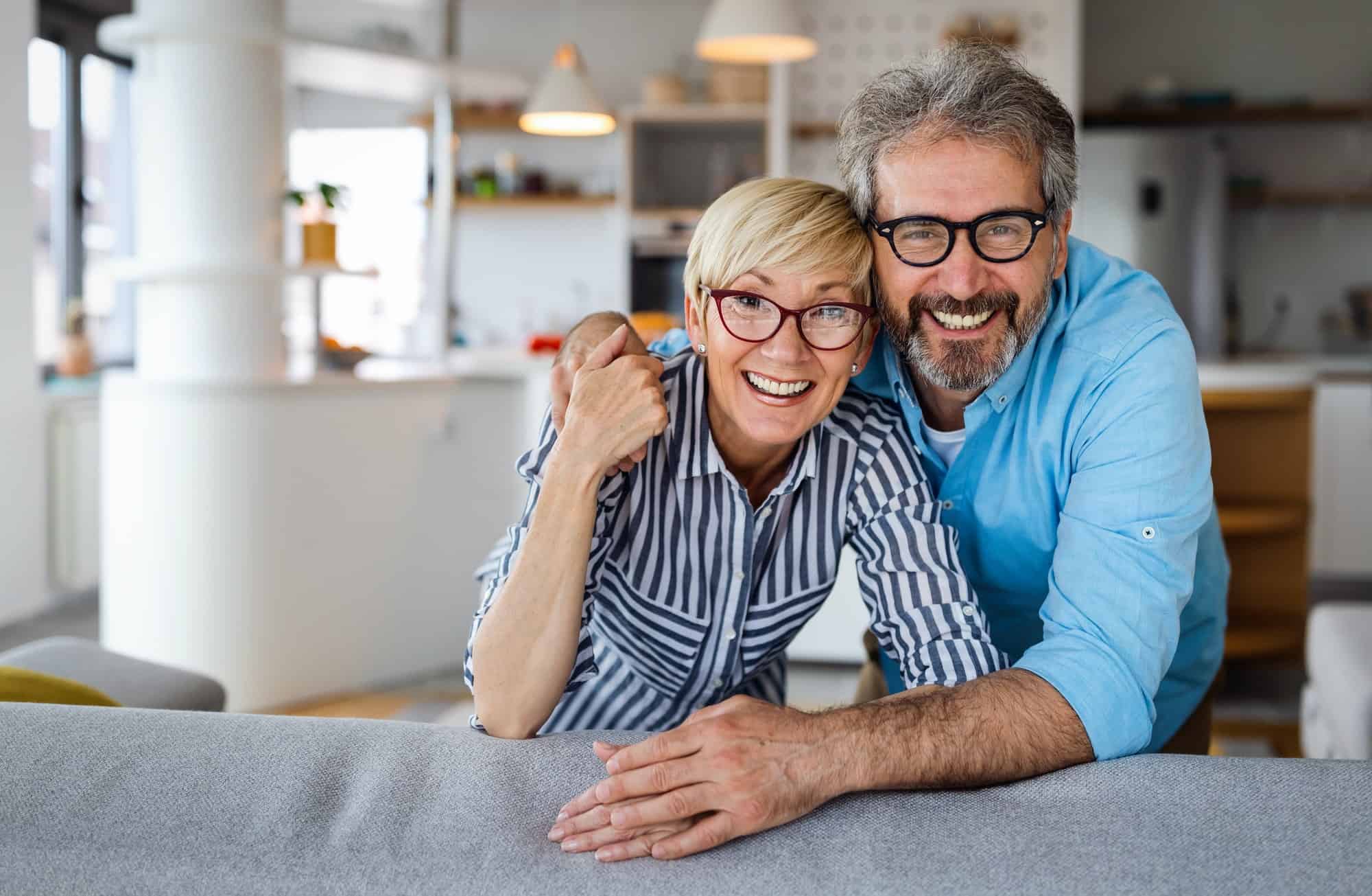 Cheerful senior couple enjoying life together, having fun at home